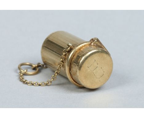 A 14 carat gold cylindrical pill box with hinged cover and safety chain by Tiffany & Co, 7.2 grams, 2.25cm.   Condition Repor