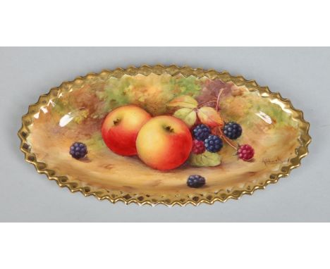 A Royal Worcester oval pin dish with serrated edge by Albert Shuck. With a gilt border and painted to the centre with apples 