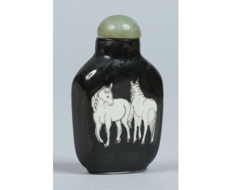 A Chinese porcelain snuff bottle with celadon jade stopper. Black ground and decorated with horses. Painted four character ma