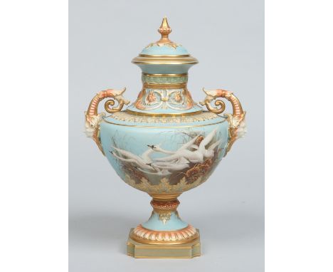 A Royal Worcester twin handled pedestal urn and cover by Charles Baldwyn. Moulded with twin mask handles and painted with swa