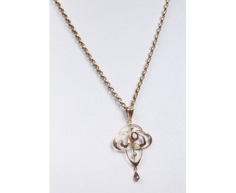 An Art Nouveau 9 carat gold openwork pendant on chain set with a round cut smokey quartz stone and a tear drop stone. Pendant