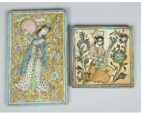 Two 19th century Persian Qajar moulded pottery tiles. Each depicting a figure, one playing a sitar and the other a tambourine