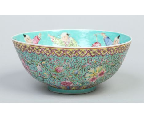 A Chinese Republic period celadon ground bowl. Painted in coloured enamels with a procession of dancing figures to the interi