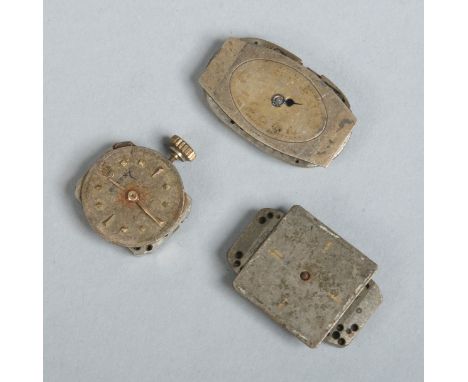 Three vintage Rolex watch movements. 