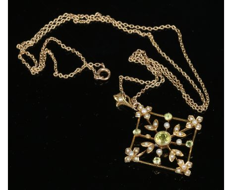 A 9 carat gold peridot and seed pearl openwork pendant on chain. Pendant 4cm including the bale.    Condition Report. To be u