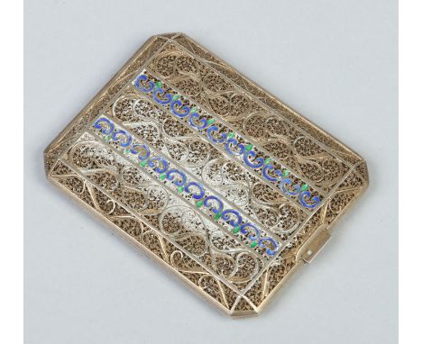 A white metal filigree cigarette case with enamel scroll work decoration, 8.25cm.   Condition Report. To be used as a guide o