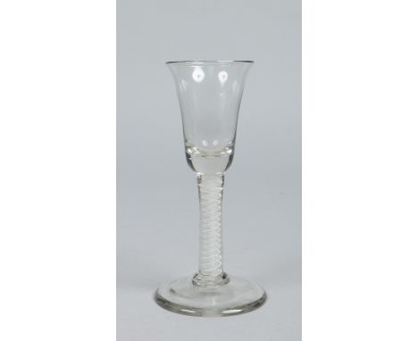 An 18th century wine glass with bell shaped bowl raised on an opaque twist stem, 16.25cm.   Condition Report. To be used as a