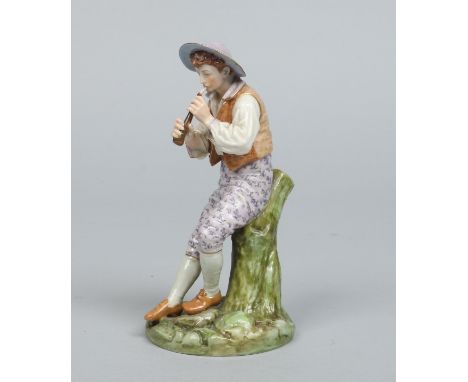 A Royal Worcester figure of a boy playing a flute seated on a tree stump over a naturalistic pad base and decorated in colour