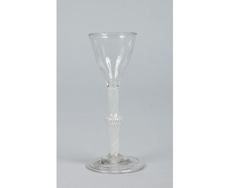 An 18th century wine glass with funnel shaped bowl raised on a knopped opaque twist stem on a folded foot, 15.5cm.   Conditio