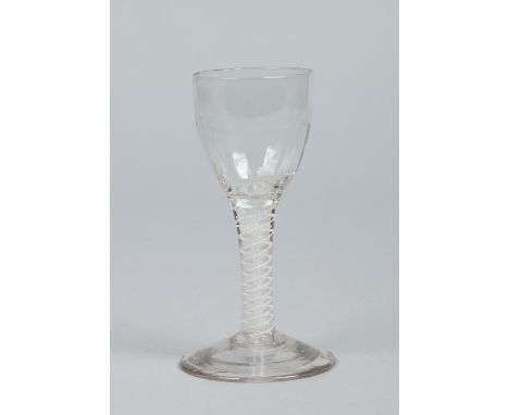 An 18th century wine glass with wrythen moulded bowl raised on a double series opaque twist stem, 12.5cm.   Condition Report.