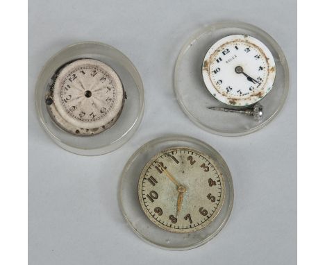 Three vintage Rolex watch movements. 