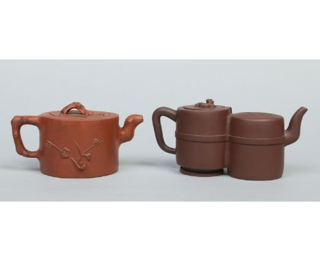 Two Chinese yixing teapots. One with branch moulded handle and spout sprigged with prunus blossom, the other of unusual twin 