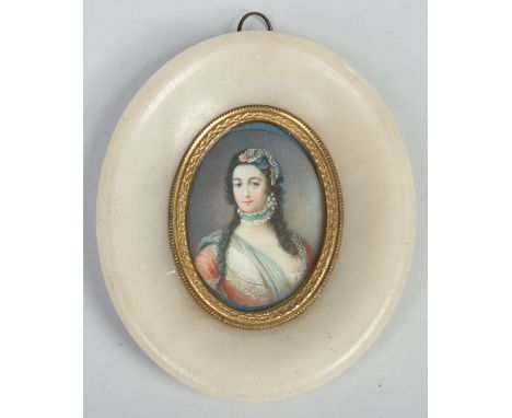 A 19th century Continental ivory portrait miniature of a noble woman in an oval alabaster frame and with pinchbeck bezel, pai