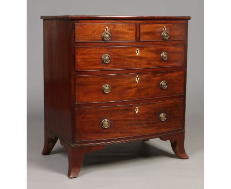 A George IV mahogany bow front two over three chest of small proportions. With strung inlay, cock beading and raised on splay