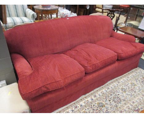 A red fabric upholstered three seat sofa, 220cm wide  