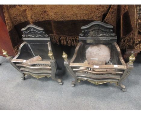 A pair of iron fire grates and a decorative grate (3)  