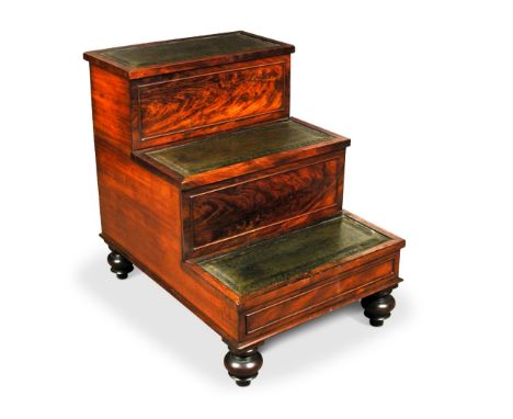 A William IV flame figured mahogany step commode, with gilt tooled green leather lined treads, hinged top step and on turned 