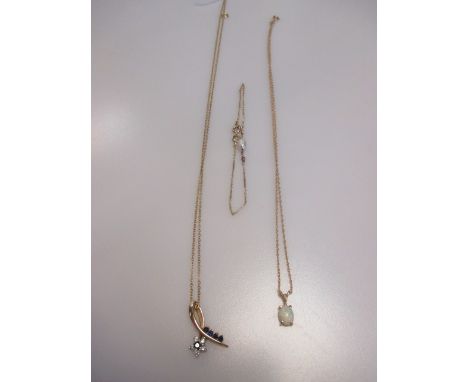 A sapphire and diamond pendant and chain, an opal pendant and chain and a chain bracelet set with a pearl and two rubies, all