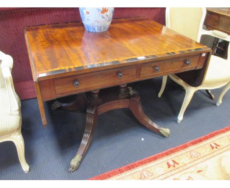 An early 19th century mahogany and calamander banded sofa table with two real and two dummy drawers on twin column platform b