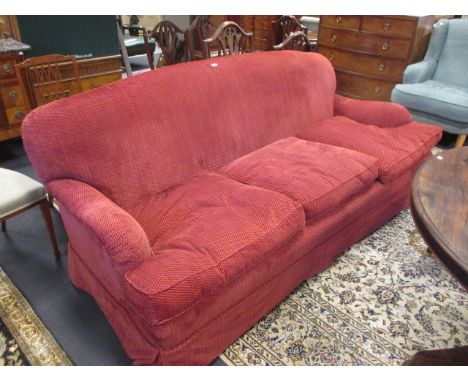 A red fabric upholstered three seat sofa, 220cm wide  