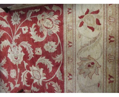 a large modern carpet with Persian floral pattern in creams and reds, 16ft x 12ft  