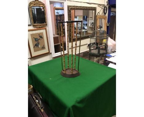 A 19th Century treen ware boot jack and a bamboo and brass and iron stick stand by Artis of Birmingham