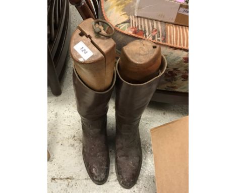 A pair of brown leather riding boots, together with a brown leather whip, the tag stamped "E Jeffries" CONDITION REPORTS Size