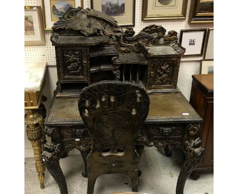 A 20th Century Chinese carved black-lacquered and painted writing table with raised superstructure and phoenix-carved back ov