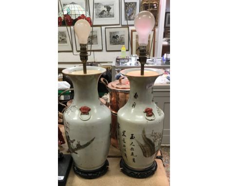 A pair of 19th Century Chinese polychrome decorated vases with relief work lion mask ring handles, the main bodies decorated 