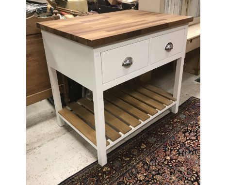 A modern Shaker Kitchen Company island, the wood top above two drawers raised on pot shelf