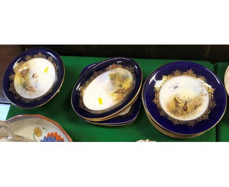 A collection of Royal Worcester game decorated dessert plates including circular plates and serving dishes all painted by G. 