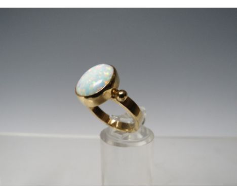 A HALLMARKED 9CT GOLD OPAL SET DRESS RING, opal within a rub over mount approx W 10 cm,  H 12 mm, ring size M                