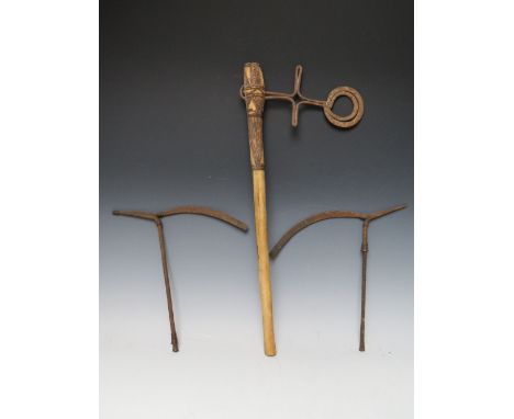 AN AFRICAN TRIBAL CEREMONIAL 'RING' AXE, with triangle and dot embellishment to the hand forged disk head, the wooden shaft w