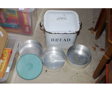 An enamel bread bin, cake tins etc.