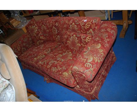 A two seater red ground sofa, 80" long x 3' deep x 31" high.