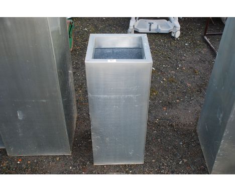 A galvanised metal square planter 12 1/2'' square x 29'' high.