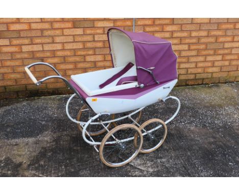 Tri-ang - A vintage metal bodied dolls pram with folding hood by Tri-ang which measures approximately 104 cm x 50 x 74 up to 