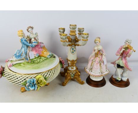 A Capodimonte centrepiece the cover with figures depicting a courting couple, two further figures and a candelabra. [4]. [W]
