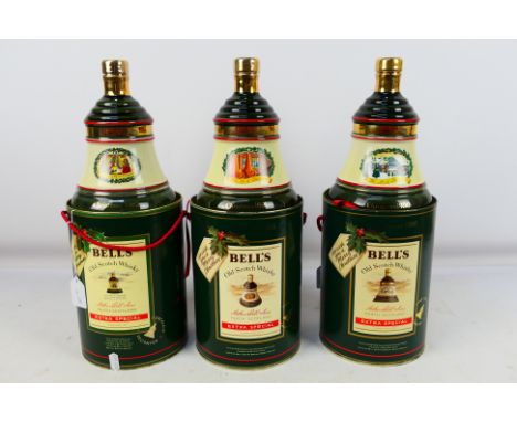 Three Bells Old Scotch Whisky decanters contained in cylindrical presentation containers, two 75cl and 43% and one 70cl and 4
