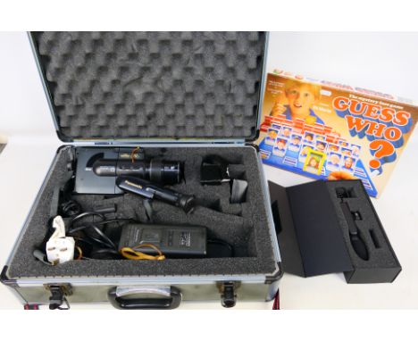 A Panasonic camcorder contained in flight case and a vintage Guess Who? game. [2]. [W]

PLEASE NOTE: ALL LOTS NEED TO BE COLL