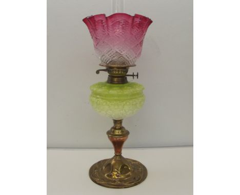 Victorian oil table lamp , brass art noveau style base with vaselene glass front , duplex burner and cranberry-clear shade an