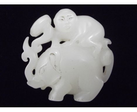 White jade okinomo of a boy riding an elephant, with carved script, height 5cm, width 5cm