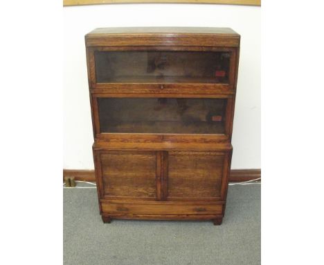 Oak Globe-Wernicke cupboard bookcase with original trade labels . two stacks over two door cupboard and two exposed drawers .