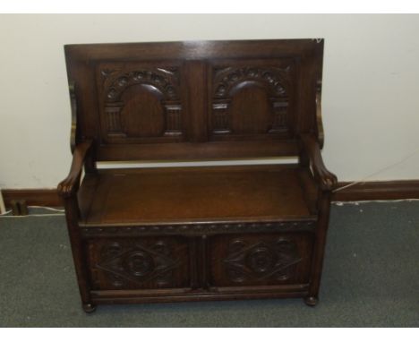 Solid oak carved monks bench , panel top with arcaded under side and carved panels . 102 x 105 x 43