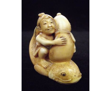 Japanese ivory netsuke in the form of a man astride a carp holding a gourd, possibly Ebisu (God of fishermen and luck) signed