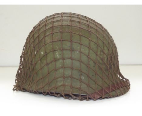 World War II pattern U.S helmet with camo net and rear seam , Vietnam period