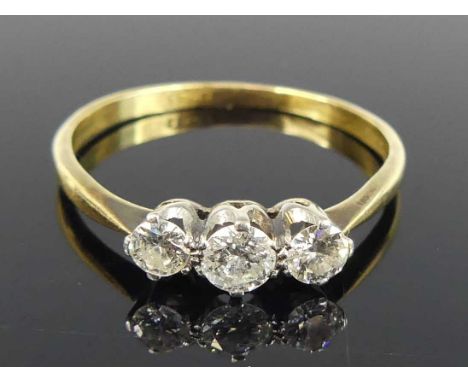 An 18ct gold diamond trilogy ring, arranged as three claw set round cuts in a line setting, total diamond weight estimated as