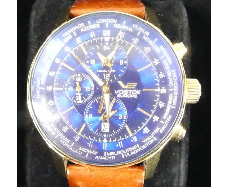 A Vostok Europe stainless steel gilt plated World Timer chronograph wristwatch, having a signed blue dial with triple subsidi