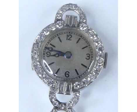 A white metal Art Deco diamond set manual wind cocktail watch, having a silvered quarter Arabic dial within a bezel set with 