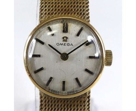 An Omega lady's 9ct gold cased bracelet watch, having a signed champagne dial with baton markers, manual wind movement, case 